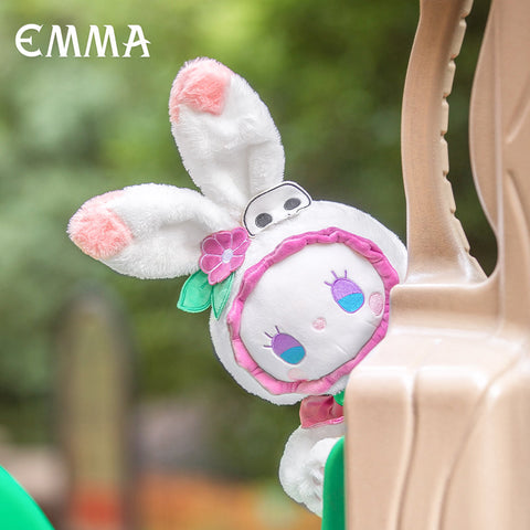 Pink and white bunny rabbit plush peeks from behind a plastic piece.