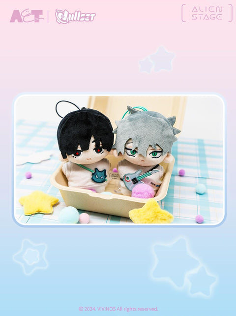 A cozy shot of the black-haired Ivan and grey-haired Till plushies sitting together in a cardboard boutique tray, highlighting their character-specific bag and guitar accessories.