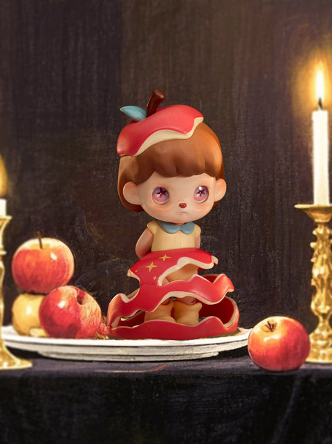 A character dressed in an apple-themed outfit stands solemnly on a dinner plate among scattered apples and lit candles. With pink eyes, a split apple hat, and a red layered skirt resembling peeling fruit, the figure stares sadly ahead. The dramatic still-life background and symbolic design emphasize fragility, temptation, and bittersweet fairytale storytelling.