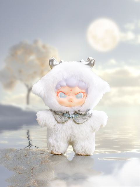 Close‑up of a chibi doll in a snowy‑white fur suit with tiny silver horns and a shimmering bow collar. The figure’s pale lavender hair and star‑filled eyes face a misty moonlit lake, where soft clouds and a lone tree reflect on the glassy water.