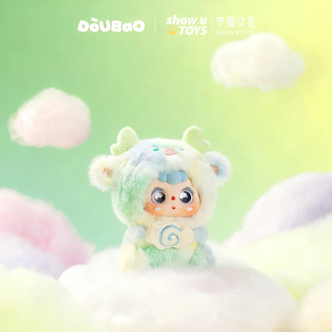 Doubao in a mint green and pale yellow dragon outfit with soft horns, sitting on a fluffy white cloud.