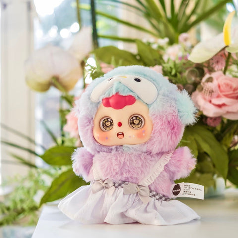 Rare hidden Penguin Doubao plush in a pastel lavender and blue fuzzy suit with a penguin face hood, wide bow, and big round sparkling eyes. The design blends icy-cute charm with fantasy flair, making this hidden edition a special highlight of the animal academy.