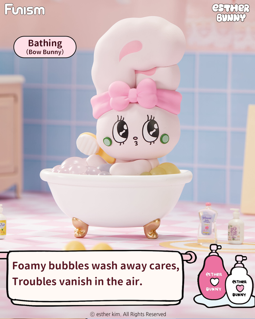 A pastel pink and white bunny figure named Bow Bunny sits in a clawfoot bathtub filled with shiny pastel bubbles. The bunny wears a pink headband bow and has wide eyes with small green cheeks. The scene is set in a pink-tiled bathroom with miniature bottles and soft lighting.