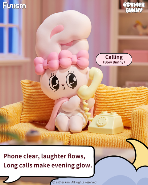 A pink and white bunny figure named Bow Bunny sits on a mustard-yellow couch holding a pale yellow rotary phone. The bunny wears a pink headband bow and scarf, gazing forward with wide cartoon eyes. The cozy living room background includes a window and striped pink walls.