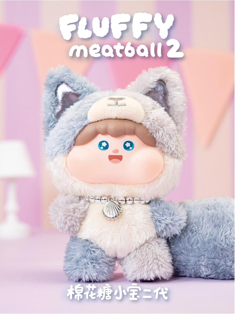 Grey fox plush with soft fur, big ears, and a fluffy tail, accessorized with a silver seashell charm necklace. Its pastel tones and round features create a gentle, collectible design that blends fantasy with cuddly realism.