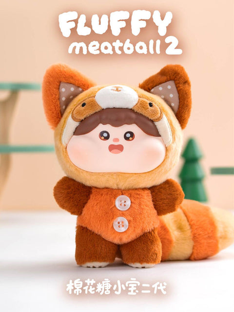 Plush figure styled as a raccoon with fuzzy brown and orange striped tail, cat-like ears, and buttoned costume. The soft texture, round cheeks, and curious face capture a cozy woodland creature aesthetic.
