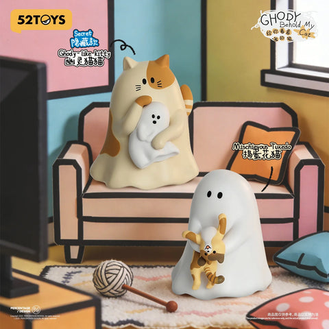 Staging of the "Ghody-like kitty" secret chaser (a large calico cat draped in a ghost sheet holding a tiny ghost) alongside "Mischievous Tuxedo" on a pink couch.