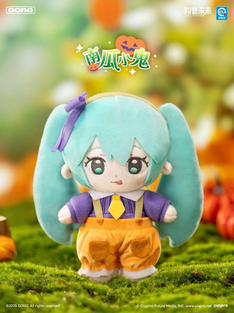 Pumpkin-themed Hatsune Miku plush dressed in orange pumpkin pants with suspenders, purple shirt, and yellow tie. She has turquoise twin tails tied with a purple bow. The grassy, pumpkin-filled background enhances the festive harvest feel, capturing a cheerful Halloween-inspired farmyard look.