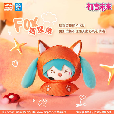 Hatsune Miku plush in a fox-style raincoat, featuring a bright orange hood with pointed ears and paw-print details. Her turquoise twin tails peek from the hood while she smiles cheerfully. Set against a peachy background with doodle stars and flowers, the design emphasizes playful, cozy rainy-day charm.