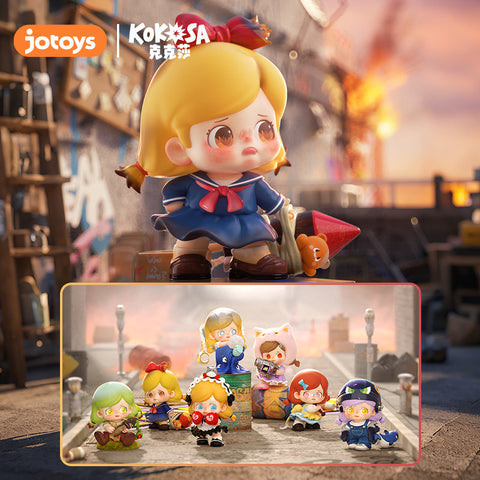 Full lineup display of the Kokosa KO Girls Series blind box, featuring seven expressive chibi-style girl figures with oversized heads, round eyes, and emotional themes. Each wears a unique outfit, from boxing gloves to costumes and accessories, all posed in an urban street setting with a gritty, cinematic feel.