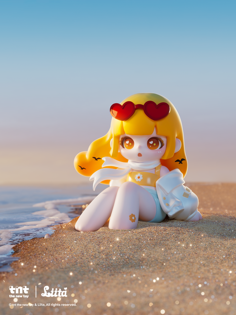 A small figurine with long yellow hair sits on a sandy shoreline at the water’s edge, wearing red heart-shaped sunglasses on her head, a white scarf, and a yellow top with a flower accent. Soft waves reach her feet as warm sunset light highlights the sparkles scattered across the wet sand around her.