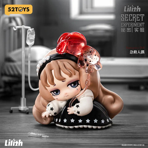A figurine from the "Lilith: Secret Experiment" blind box series titled "Emergency Doll" shows a sad-eyed character dressed in a black dress with star trim and a pearl headband. She clutches her chest while connected to a translucent red IV bag shaped like a bunny. The background features a grayscale hospital room with a bed and IV stand, enhancing the eerie and emotional atmosphere of this medically themed, gothic-inspired collectible.