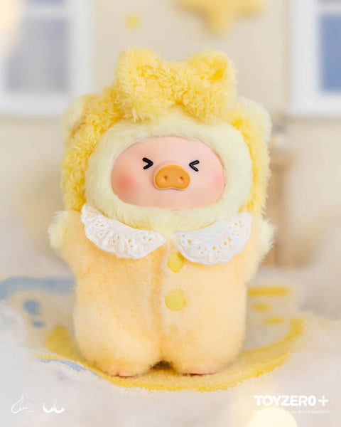 A yellow plush pig in a fluffy bear suit stands on a soft surface with a star-shaped accent nearby. The suit includes rounded ears, a lace collar, and yellow buttons. The pig’s tightly closed eyes and expressive posture give an excited, triumphant look matching the winning-streak theme.