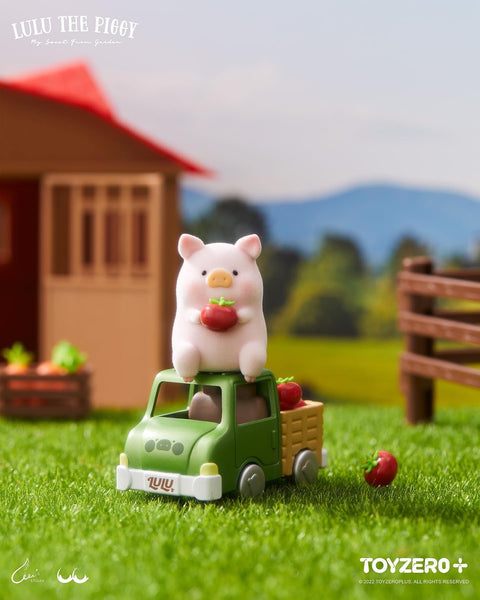 The rare chaser featuring a flocked LuLu piggy sitting on the roof of a green farm truck filled with red tomatoes.