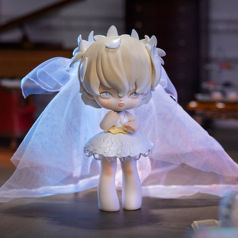 A 3D-rendered MISYA Incredible Mansion Series figure stands elegantly in a dimly lit vintage room. The character has delicate white hair adorned with petal-like details, pale blue eyes, and a serene, melancholic expression. She wears a feathered white dress with a translucent veil flowing behind her, resembling a ghostly bride. Soft lighting casts an ethereal glow, enhancing the mysterious, dreamlike atmosphere, while antique furniture in the background adds to the gothic aesthetic.