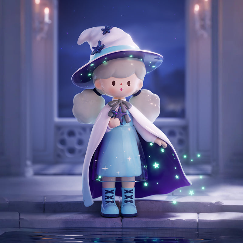 A small figure in a sky-blue cape and star-dotted hat stands before glowing candles, its outfit illuminated by a field of drifting green stars. The soft shimmer across its cloak evokes the feeling of midnight magic, where galaxies whisper through gentle starlight.