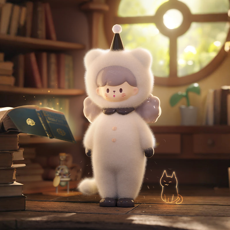 A small vinyl figure with light gray hair wearing a fuzzy white cat costume with a black collar and buttons, black gloves and shoes, and a pointed black hat with a white tip. The figure stands in a warm, softly lit room with wooden shelves, books, and a round window behind it. A small glowing cat outline is on the floor nearby.
