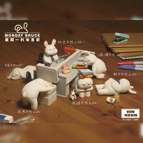 Full display of the Monday Bruce Series 1 figures, showing six bunnies in humorous office-life poses: slouched, lying flat, exhausted at a copier, hiding under folders, staring at a laptop, and passed out.