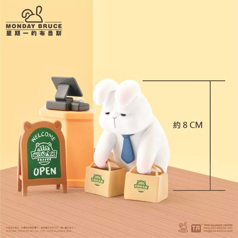 A tired bunny in a blue tie carries two Croak Coffee bags beside a register counter with a welcome sign. Its slouched posture captures the weary feel of running morning errands before work in this collectible design.