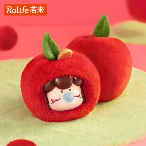 A Nanci Fruit Mood plush styled as a red apple, its fluffy round body with a small green felt leaf on top. Inside, the figure has a calm, closed-eyed expression, bubblegum bubble at its mouth, and simple facial details, merging fruit inspiration with cozy plush doll aesthetics.