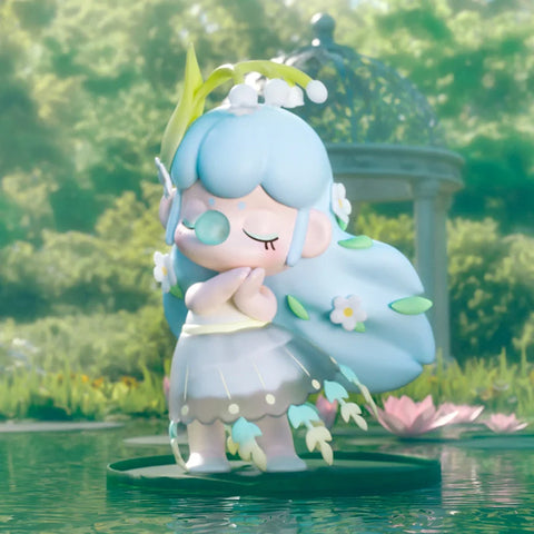 Nanci standing on a lily pad. The bottom of her dress has feathers. 