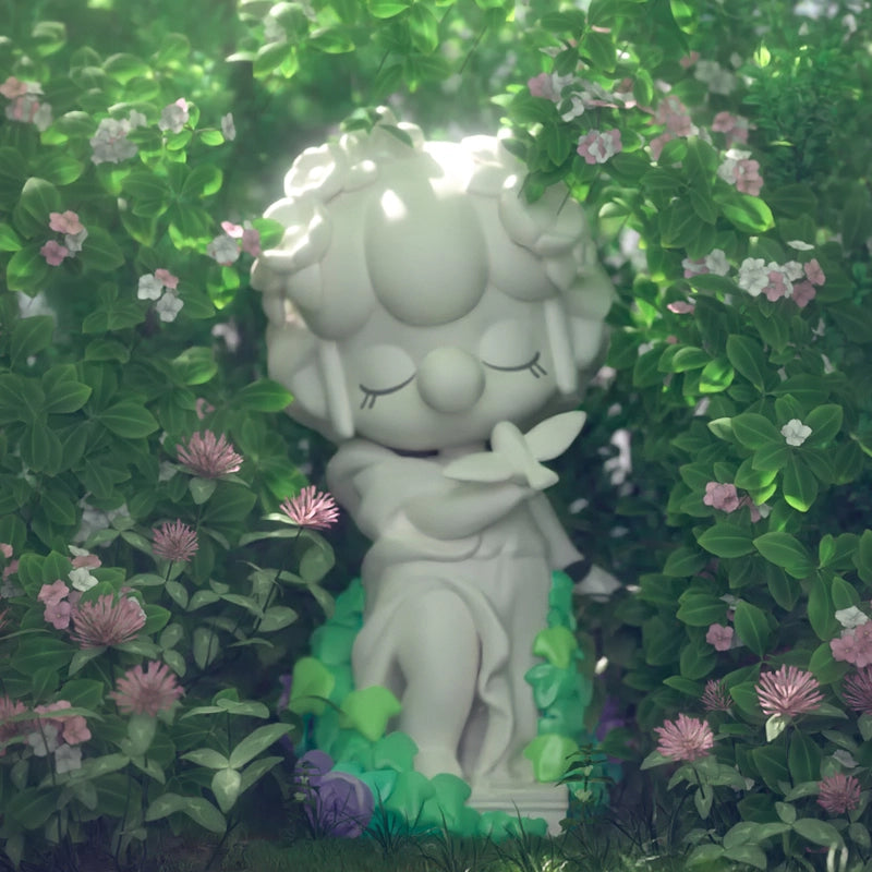 Nanci as a statue. There is a statue bird on top of her right hand. 
