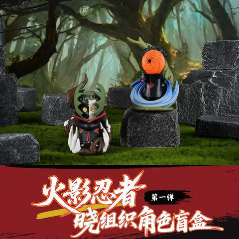 Figures of Tobi and Zetsu stand on stone bases. Tobi has his orange spiral mask and a swirl of blue energy, while Zetsu is half green and half black, emerging from a plant-like structure with detailed sharp teeth and leafy extensions.