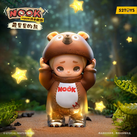 A chibi child figurine stands on a forest path dressed in a brown bear costume with rounded ears and a bear face on the hood. The character lifts the hood with both hands, showing a gentle smile and wide eyes. Glowing yellow star lights float around their translucent, glittery lower body and feet.