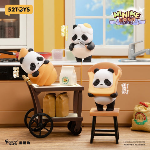 Three panda figures pose in a warm kitchen scene. One panda is wrapped inside a croissant costume, another stands on a stool with a piece of toast framing its face, and a third wears a cracked egg hat while stirring with a spoon. Surrounding props include flour bags, a cart, and counter items.