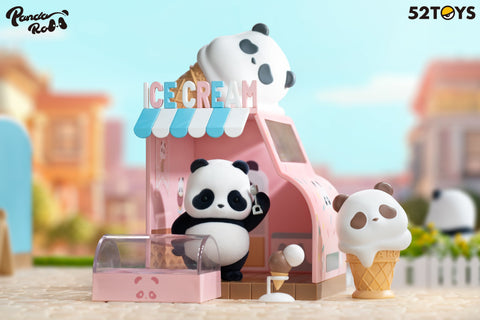 A panda figurine from the 52TOYS Panda Roll Shopping Street series stands inside a pink ice cream shop with a curved roof and a panda-head cone on top. The panda holds a scoop behind a clear display case, with a cone prop beside it. A large panda-faced ice cream cone and sprinkle-themed decor complete the playful scene.