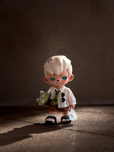 A blonde-haired figure stands under a beam of warm light on a textured floor. Wearing a striped shirt, brown shorts, and black sandals, the character holds a green bag and a small plastic pouch with a goldfish inside.