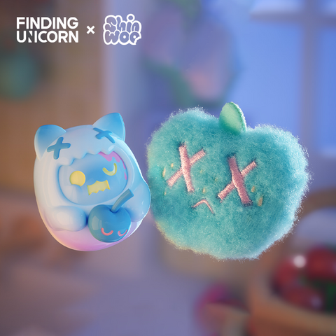 A duo of floating figures shown in soft blue light. On the right, a small vinyl character with cat ears and pale blue coloring holds a blue cherry, its hood decorated with stitched X marks. To the left is a fuzzy teal apple-shaped plush embroidered with pink stitched X eyes and a short green stem.