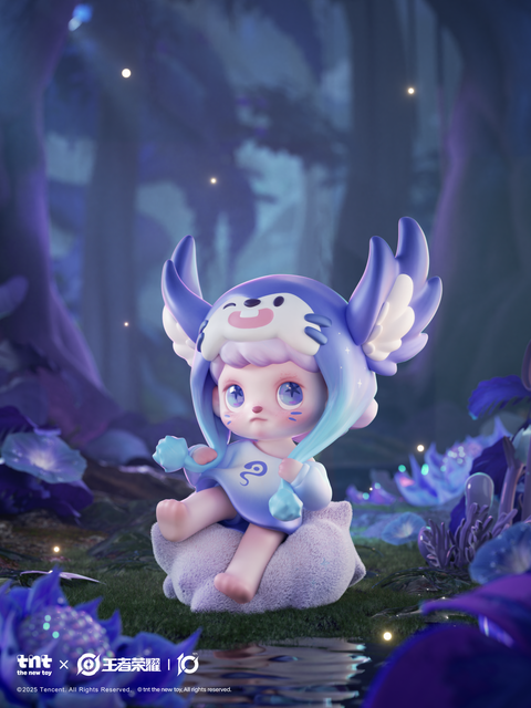 A small pastel-blue character sits on a cushion in a glowing forest. The figure wears a hood with wing-like ears and holds two crystal-like gems. Light sparkles among surrounding blue flowers and water reflections, creating a dreamlike night atmosphere.