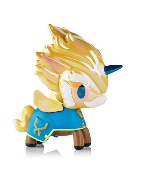 A Tokidoki Arcane Unicorno figure based on Heimerdinger stands against a white background, featuring fluffy sculpted hair, goggles, gold chrome accents, and mechanical motifs. Engraved tech-inspired lines and metallic elements adapt Heimerdinger’s design into the rounded Unicorno form.
