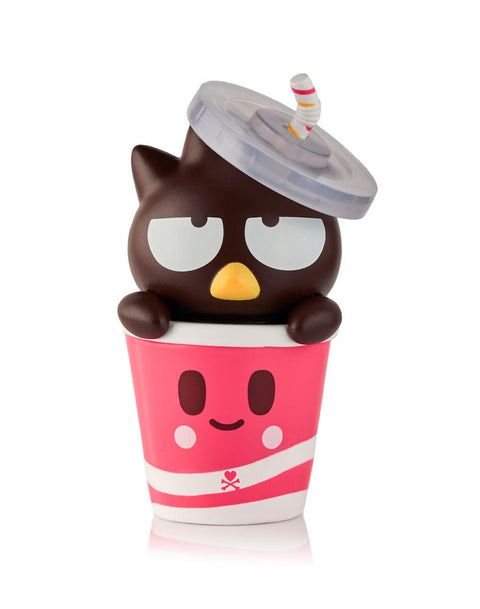 A rare dark brown Badtz-Maru figure popping out of a pink soda cup that features a smiling face, white stripes, and a clear dome lid with a striped straw.