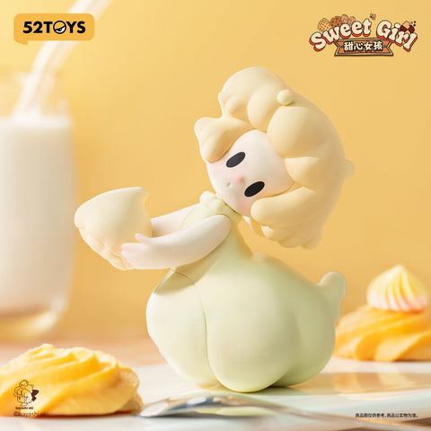 A pale yellow figurine girl with rounded hair swirls, leaning playfully while holding a cookie piece. Her puffed skirt resembles airy meringue, placed beside whipped cookies and a glass of milk.