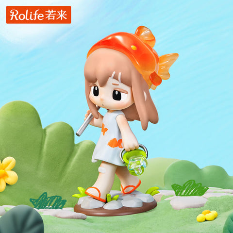 A girl in a white dress with orange goldfish patterns carries a small bucket and straw, wearing a translucent goldfish-shaped hat. She walks along green grass and stepping stones with a curious look. This detailed figure captures tranquil summer adventures of exploring streams and catching fish.