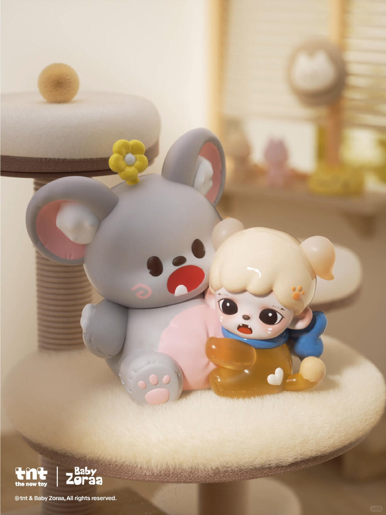 A chibi-style cat girl with twin braids and pink ribbons stands shyly in a red polka-dot dress with a white collar and bow shoes. She looks downward beside a spilled pink cup and bowl of kibble, framed by warm wooden furniture and soft morning light.
