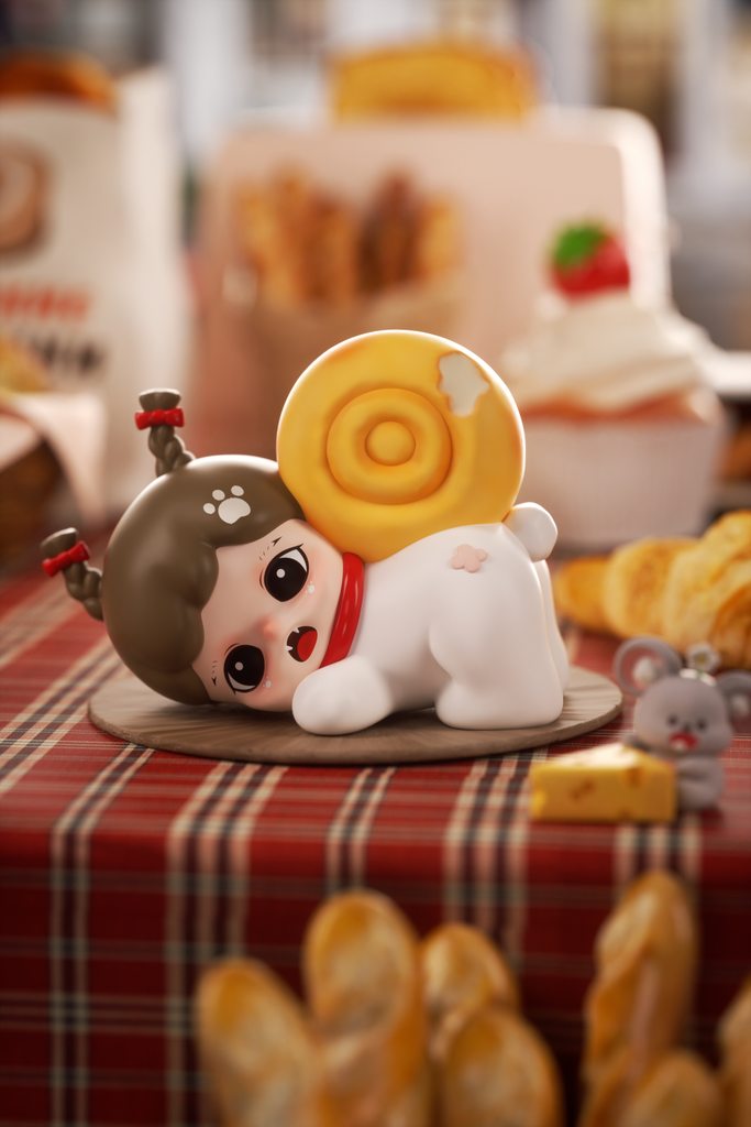 A small figurine styled as a girl-dog hybrid with brown hair and red bows poses on a checkered tablecloth. She wears a white outfit and has a yellow spiral pastry on her back like a snail shell. The background includes bread, desserts, and a tiny gray mouse holding cheese.