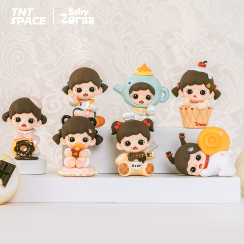 A collection of six chibi-style figures from the Zoraa Baby Bakery Series is displayed on a white shelf. Each figure features the same brown-haired girl styled with pastries and sweets like donuts, bread, teapots, and cupcakes. Logos for TNT Space and Baby Zoraa appear above.