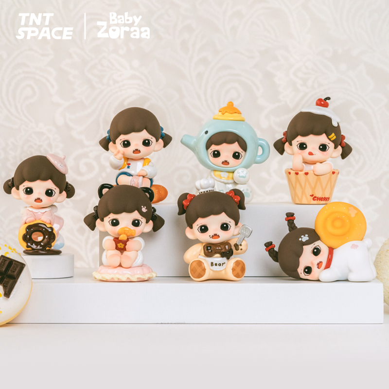 A collection of six chibi-style figures from the Zoraa Baby Bakery Series is displayed on a white shelf. Each figure features the same brown-haired girl styled with pastries and sweets like donuts, bread, teapots, and cupcakes. Logos for TNT Space and Baby Zoraa appear above.