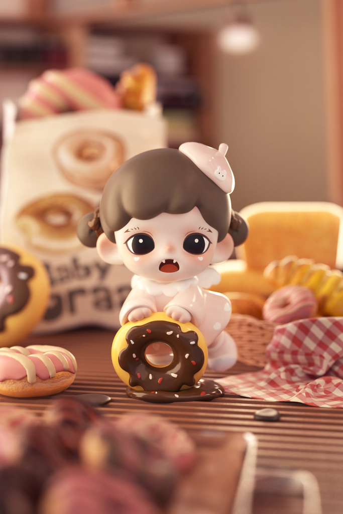 A small figurine of a girl with brown hair in pigtails and a white beret shaped like a dollop of cream poses with a yellow donut. Chocolate icing and sprinkles drip from the donut onto the table, surrounded by pastries and checkered cloth under soft warm bakery light.